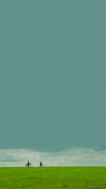 Two Cyclists Under a Minimalist Sky 4K Wallpaper