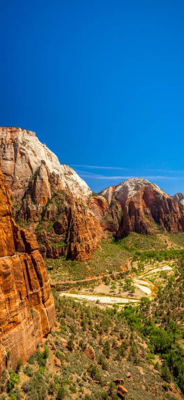 Tranquility Canyon Landscape Wallpaper: Red rocky cliffs with blue sky