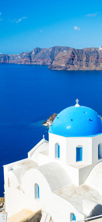 Blue roof and white wall buildings in Santorini phone wallpaper
