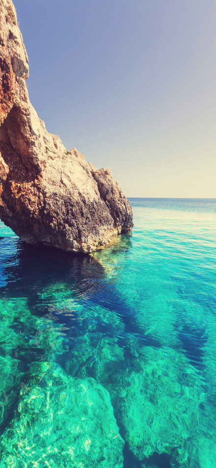 Clear turquoise sea by the beach phone wallpaper