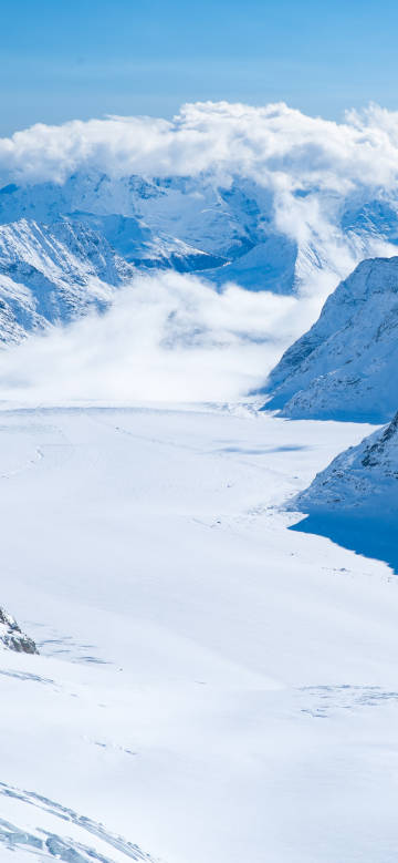 Magnificent snow-capped mountains surrounded by clouds