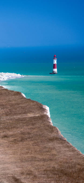 Beautiful view of tranquil seaside lighthouse phone wallpaper