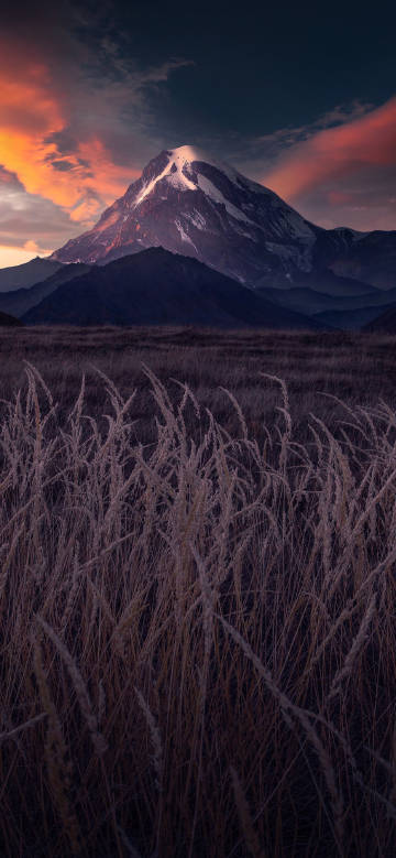 Stunning view of towering snow-capped mountains at sunset