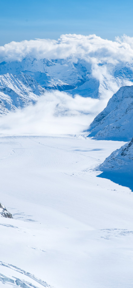 Magnificent snow-capped mountains surrounded by clouds