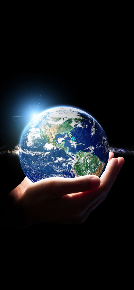 Hand Holding Glowing Planet Earth in Dark Space 4K Wallpaper