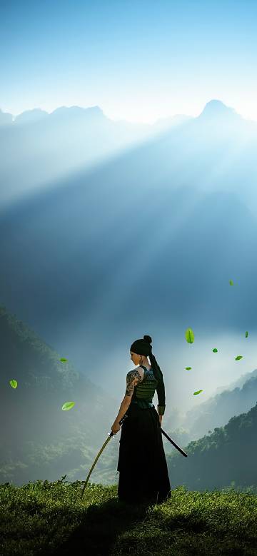 Female Warrior with Katana Overlooking Misty Valley Wallpaper