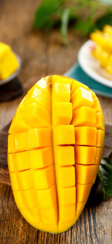 Ripe Yellow Mango Cut into Cubes Close-up 8K Wallpaper