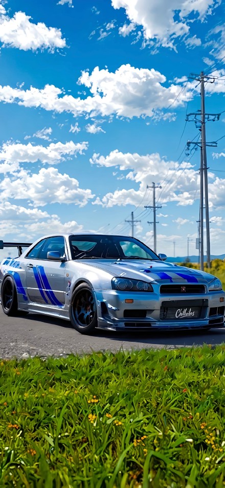 Silver Nissan R34 GTR Driving Under Blue Sky