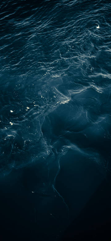 A deep blue sea with undulating water phone wallpaper