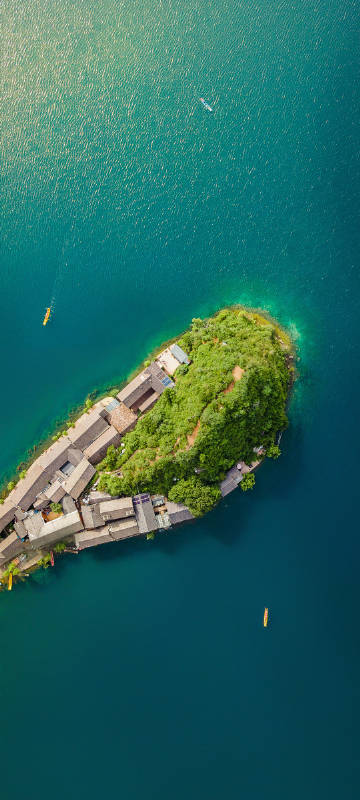 Overlooking the lake island surrounded by clear water phone wallpaper
