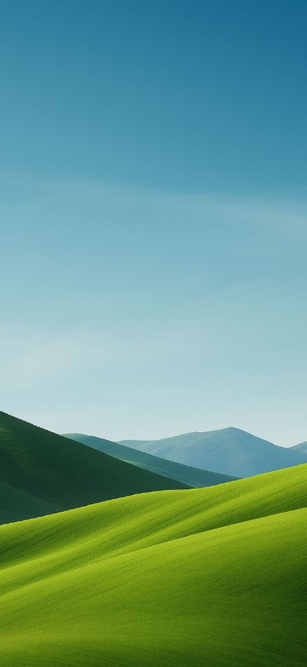 Green hills under clear sky phone wallpaper