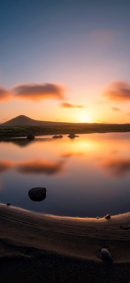 Tranquil lake scenery at sunset phone wallpaper