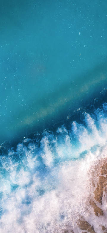 Waves hitting the beach phone wallpaper