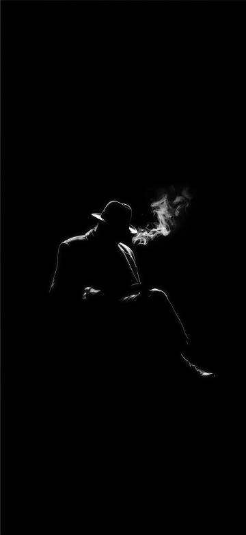 Gentleman smoking on black background