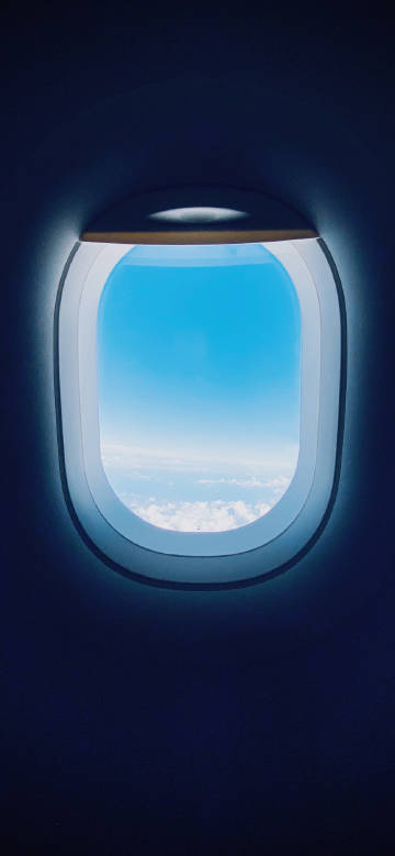 Blue sky and white clouds outside the airplane window phone wallpaper