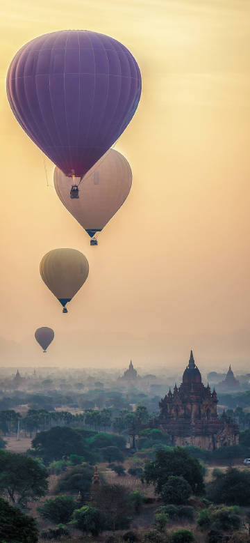 Hot air balloon flight among pagodas phone wallpaper