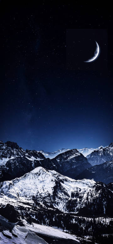 Magnificent snow-capped mountains under the deep blue starry sky