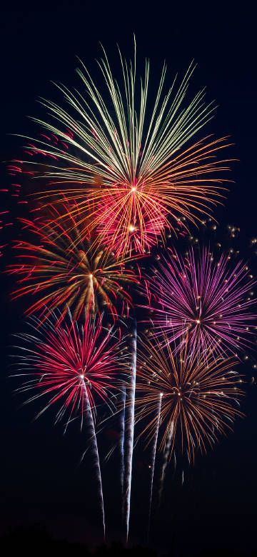 Gorgeous fireworks show under the night sky phone wallpaper