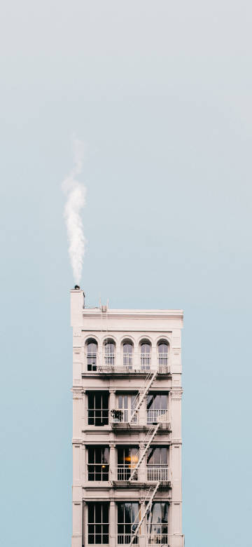 Building with smoke on roof phone wallpaper