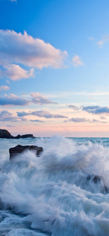Waves, blue sky and white clouds, sunset, rocks